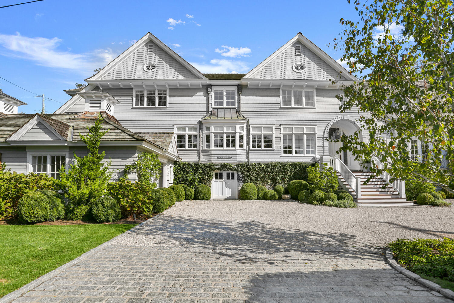 43 Contentment Island Road Darien, CT 06820 - Photo 2 of 59 a front view of a house with a yard and potted plants