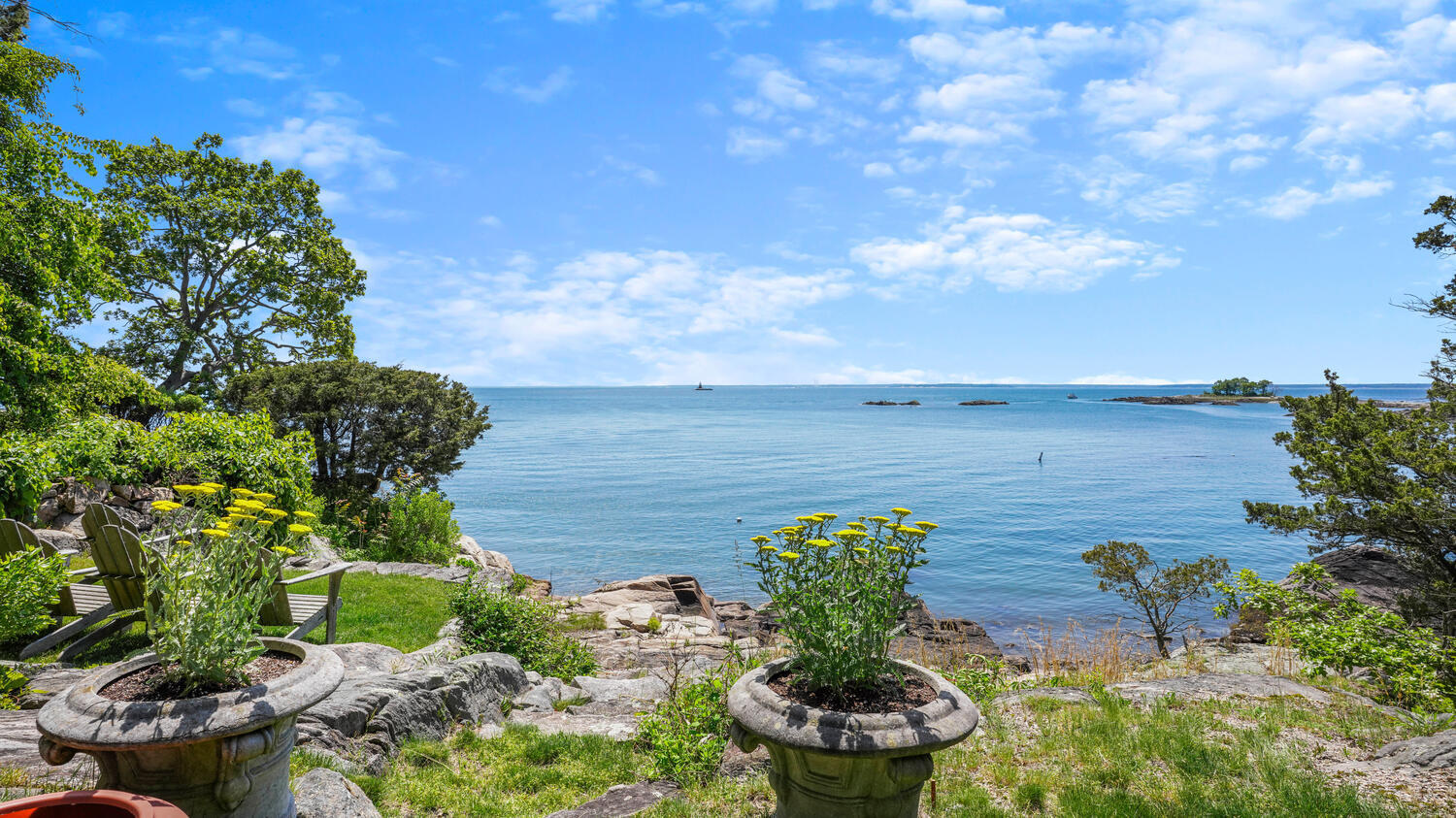 43 Contentment Island Road Darien, CT 06820 - Photo 49 of 59 a view of a garden with plants and a fountain