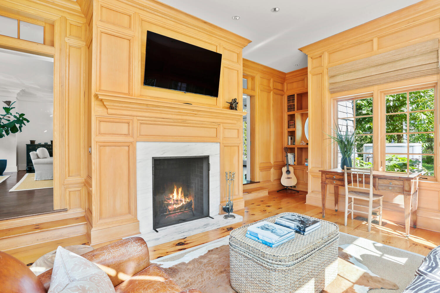 43 Contentment Island Road Darien, CT 06820 - Photo 10 of 59 a living room with furniture a fireplace and a flat screen tv