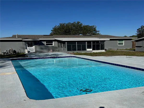 a front view of a house with a yard table and chairs
