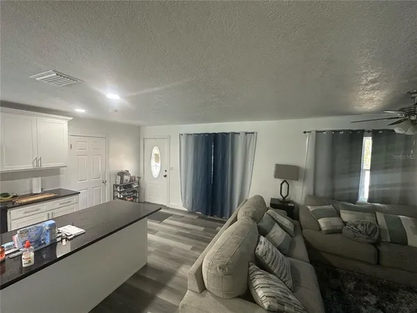 a living room with furniture and a lamp