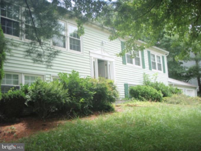 1803 Post Oak Trail Reston, VA 20191 - Photo 1 of 17 a front view of a house with garden
