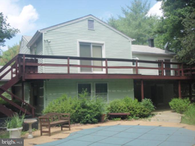 1803 Post Oak Trail Reston, VA 20191 - Photo 14 of 17 a front view of a house with garden and plants
