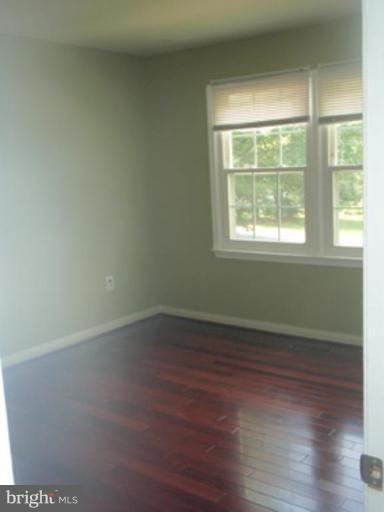 1803 Post Oak Trail Reston, VA 20191 - Photo 8 of 17 an empty room with wooden floor and windows