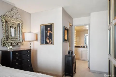 a bedroom with a bed and a mirror