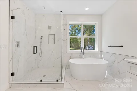 a white bath tub sitting next to a shower