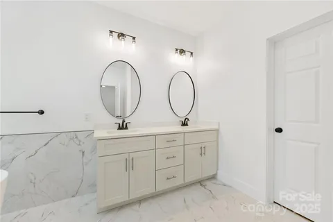 a bathroom with 2 sink and a mirror