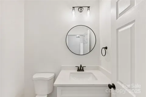a bathroom with a toilet a sink and a mirror