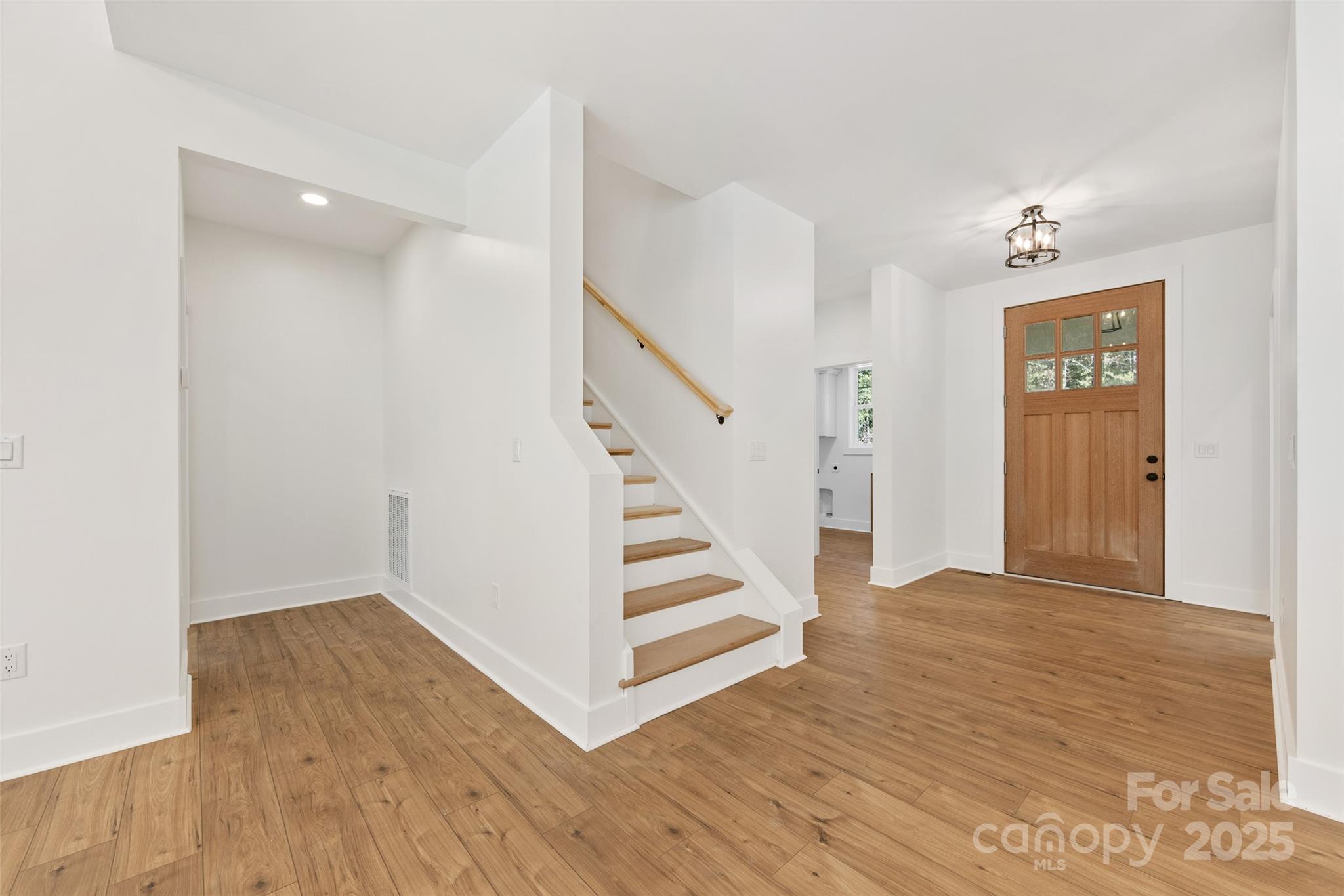 1871 Lynmore Drive Sherrills Ford, NC 28673 - Photo 2 of 40 a view of a hallway with wooden floor and staircase