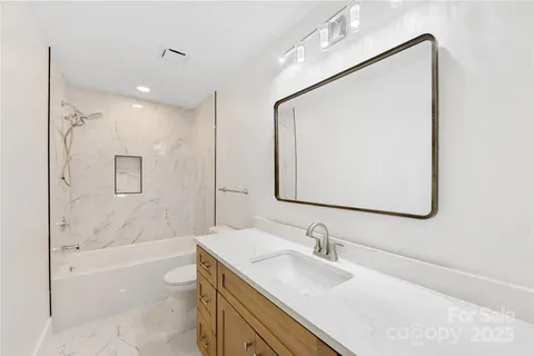 a bathroom with a bathtub and a sink