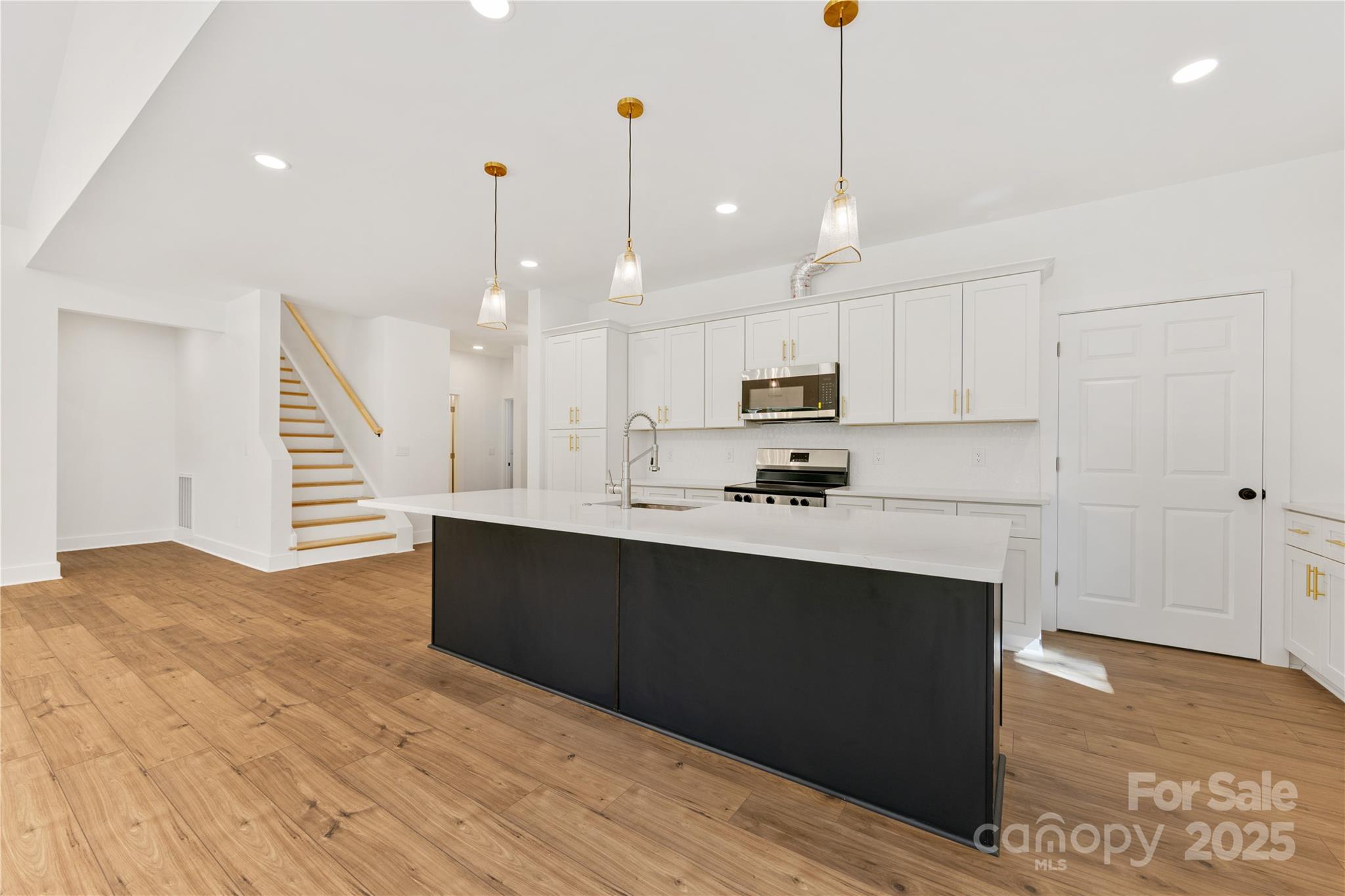 1871 Lynmore Drive Sherrills Ford, NC 28673 - Photo 3 of 40 a kitchen with kitchen island a sink stainless steel appliances and cabinets