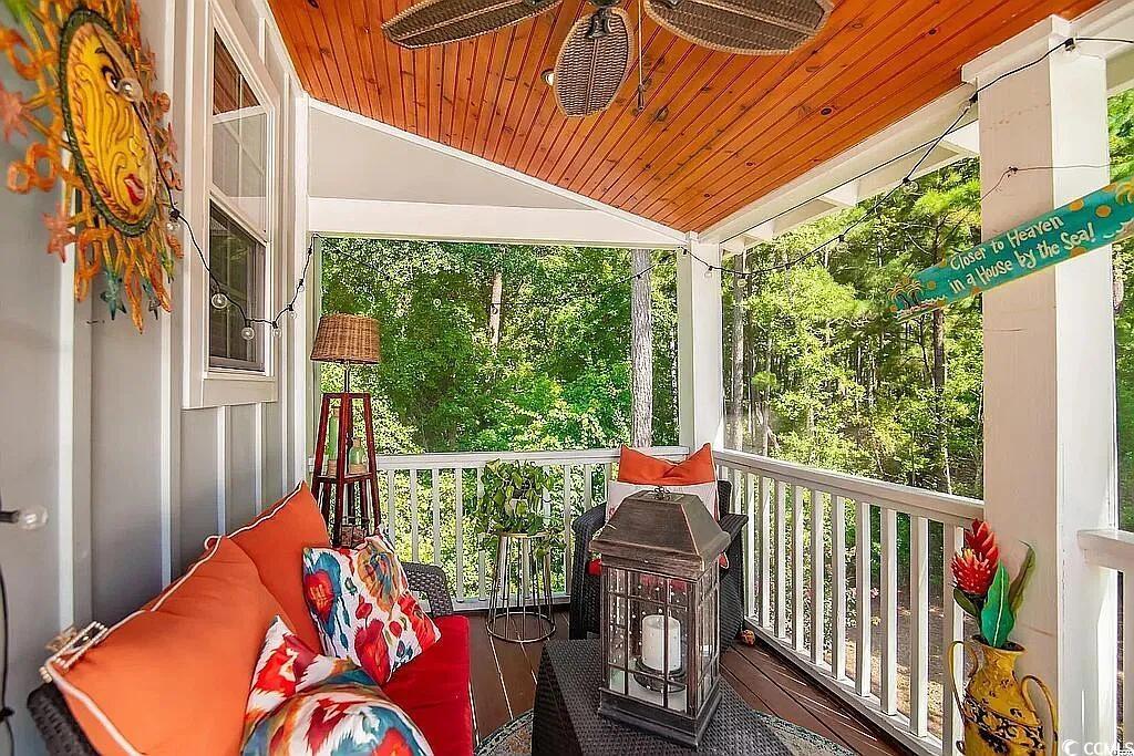 399 Lumbee Circle Pawleys Island, SC 29585 - Photo 13 of 30 Wooden deck with a ceiling fan and view of scattered trees