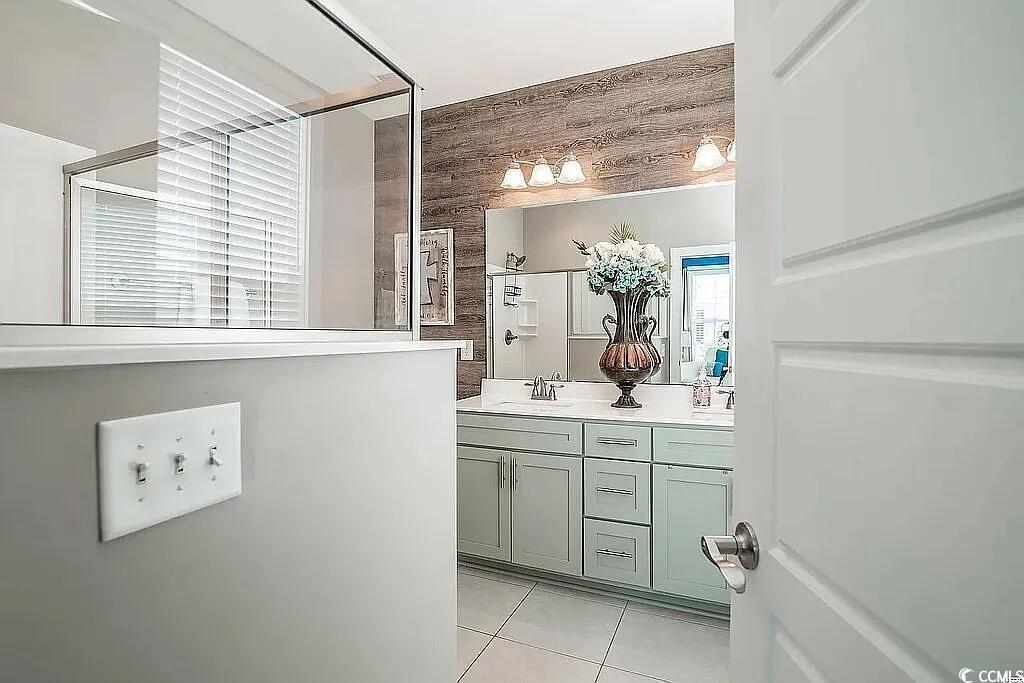 399 Lumbee Circle Pawleys Island, SC 29585 - Photo 17 of 30 Bathroom with vanity, light tile patterned flooring, and a stall shower