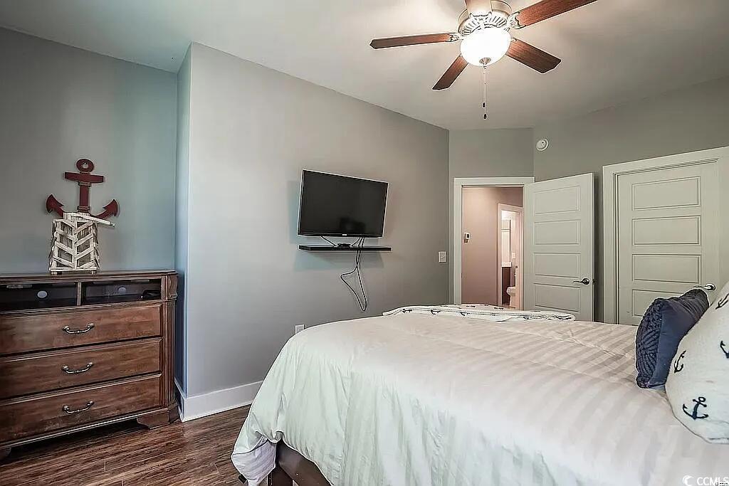 399 Lumbee Circle Pawleys Island, SC 29585 - Photo 23 of 30 Bedroom with dark wood finished floors and ceiling fan