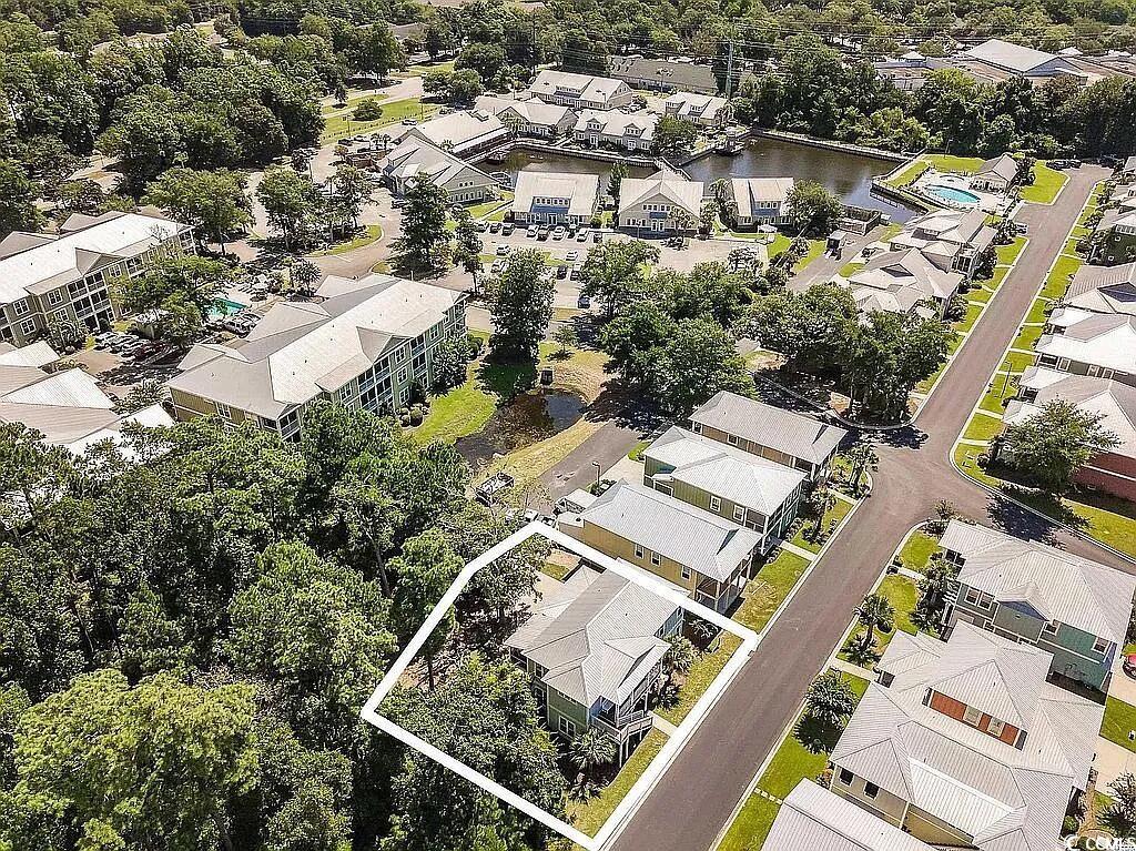 399 Lumbee Circle Pawleys Island, SC 29585 - Photo 26 of 30 Aerial view of property and surrounding area featuring nearby suburban area and a large body of water