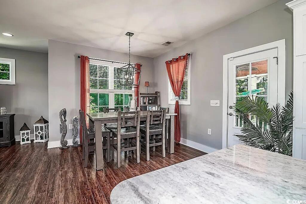 399 Lumbee Circle Pawleys Island, SC 29585 - Photo 8 of 30 Dining area featuring dark wood-style floors