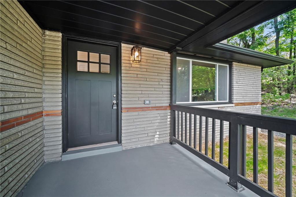 271 Forest Grove Road Coraopolis, PA 15108 - Photo 2 of 40 a view of a porch with wooden floor and stairs