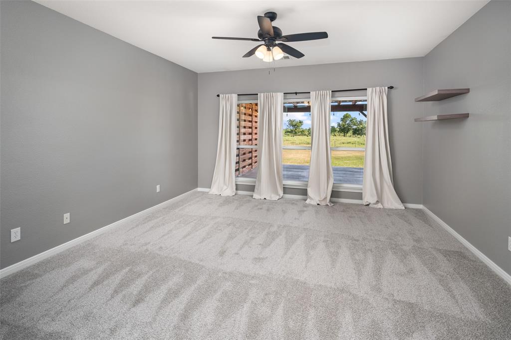 1019 Vaughan Lane Tioga, TX 76271 - Photo 22 of 40 Spacious room featuring light gray carpet flooring and neutral gray walls