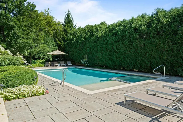 a view of yard with swimming pool and green space