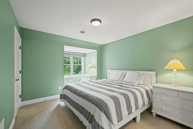 a bedroom with a bed and a table