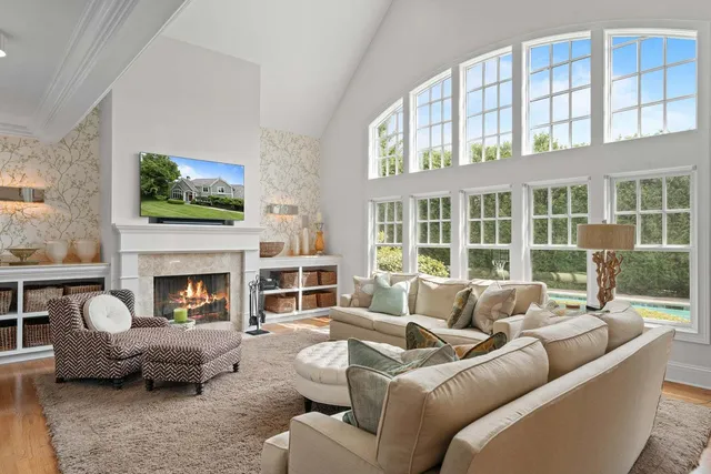 a living room with furniture a fireplace and a flat screen tv