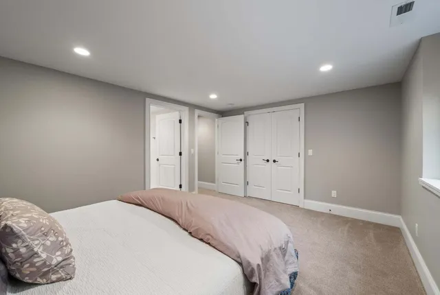 a bedroom with a large bed and a window