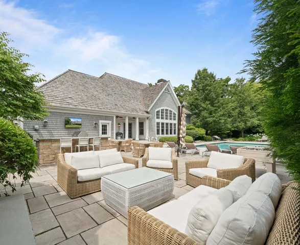 a outdoor space with patio fireplace couches and a potted plant