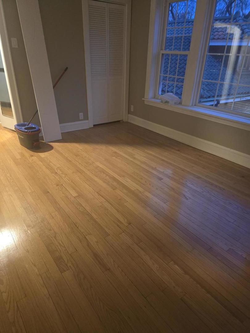 9632 South Charles Street, Unit 2R Chicago, IL 60643 - Photo 2 of 4 a view of an empty room with wooden floor and a window