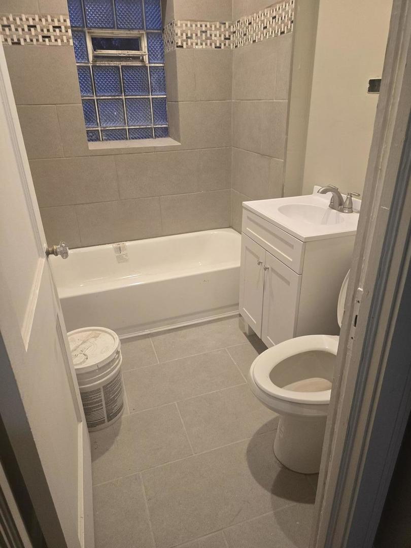 9632 South Charles Street, Unit 2R Chicago, IL 60643 - Photo 3 of 4 a white toilet sitting next to a bath tub