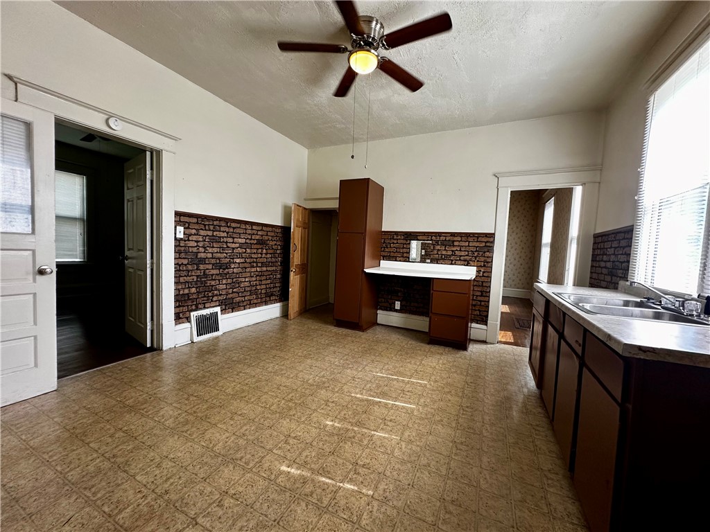 996 West Packard Street Decatur, IL 62522 - Photo 3 of 14 a view of a kitchen with furniture and a ceiling fan