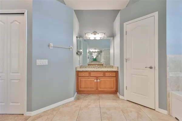 a bathroom with a granite countertop sink a toilet and a mirror