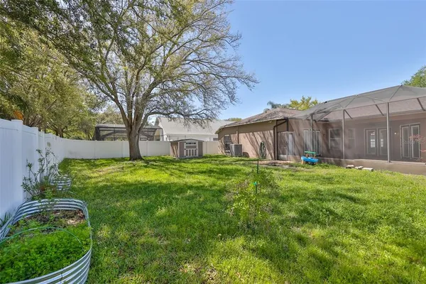 an aerial view of residential houses with outdoor space and trees