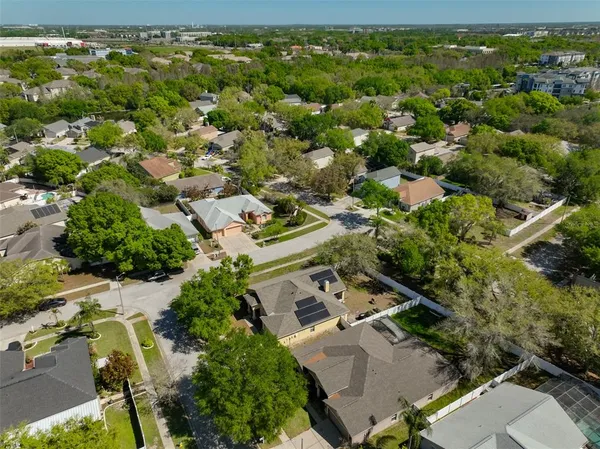 an aerial view of a house with a yard
