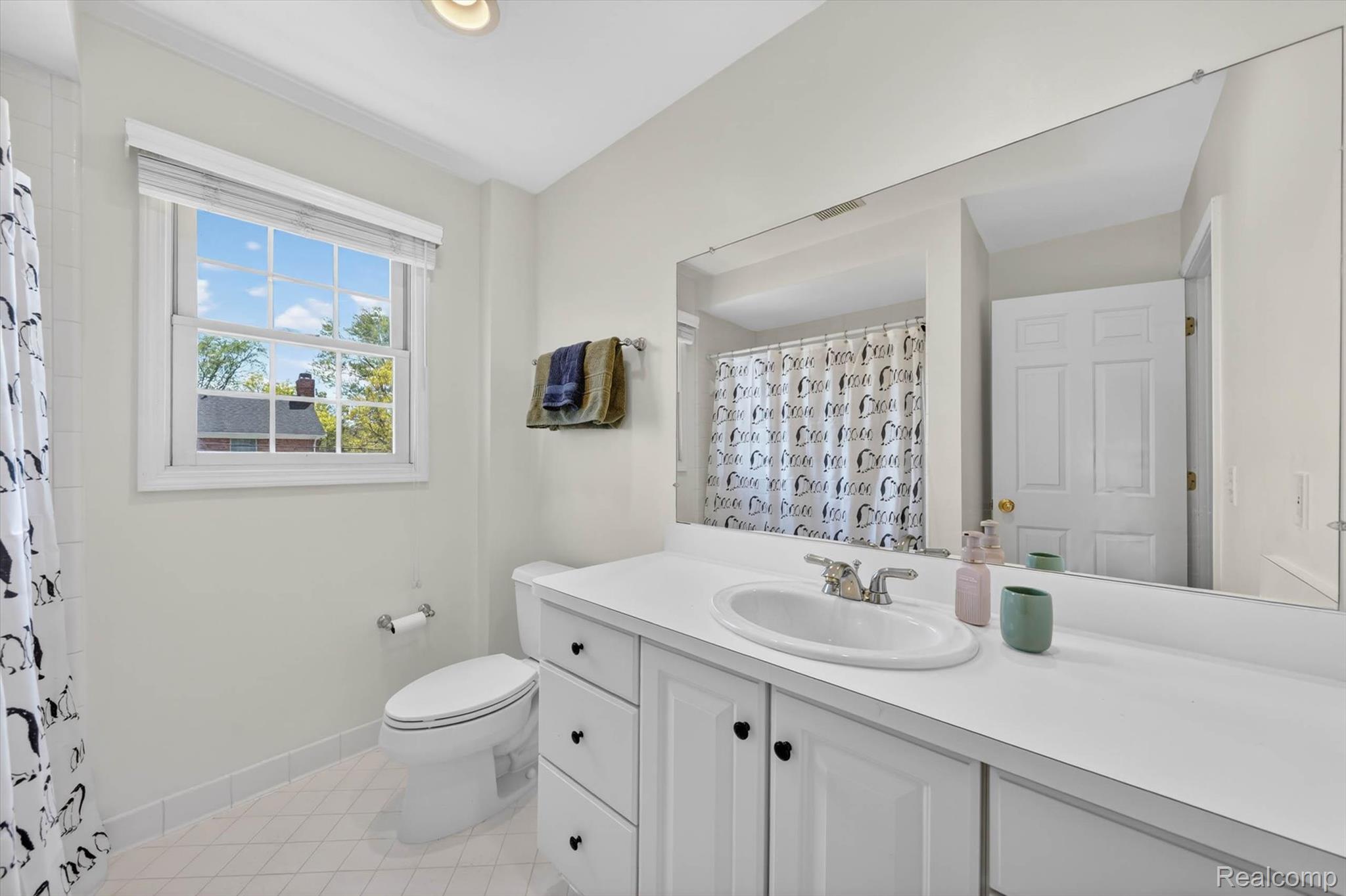1112 Vernier Road Grosse Pointe, MI 48236 - Photo 23 of 39 Full bath featuring vanity, a shower with shower curtain, and light tile patterned flooring