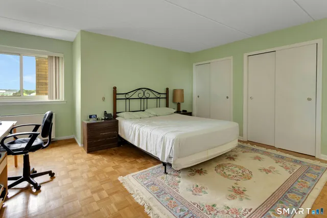 a bedroom with a bed a table and chair