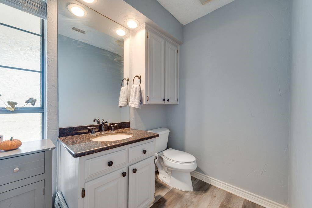 83 Crown Road Willow Park, TX 76087 - Photo 21 of 35 White vanity with a neutral-toned countertop and an undermount sink