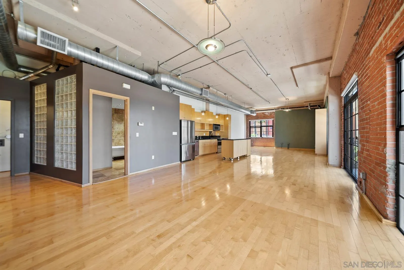 3940 7th Avenue, Unit 206 San Diego, CA 92103 - Photo 17 of 54 a view of a hallway with wooden floor