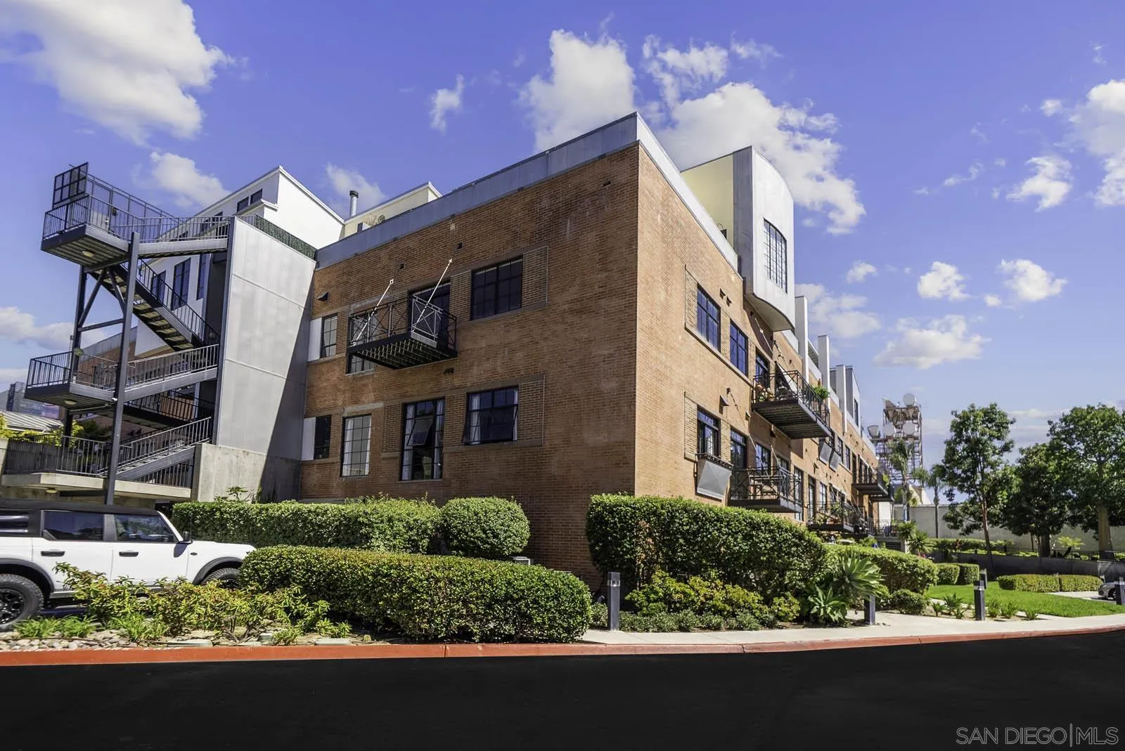 3940 7th Avenue, Unit 206 San Diego, CA 92103 - Photo 3 of 54 a front view of a residential apartment building with a yard
