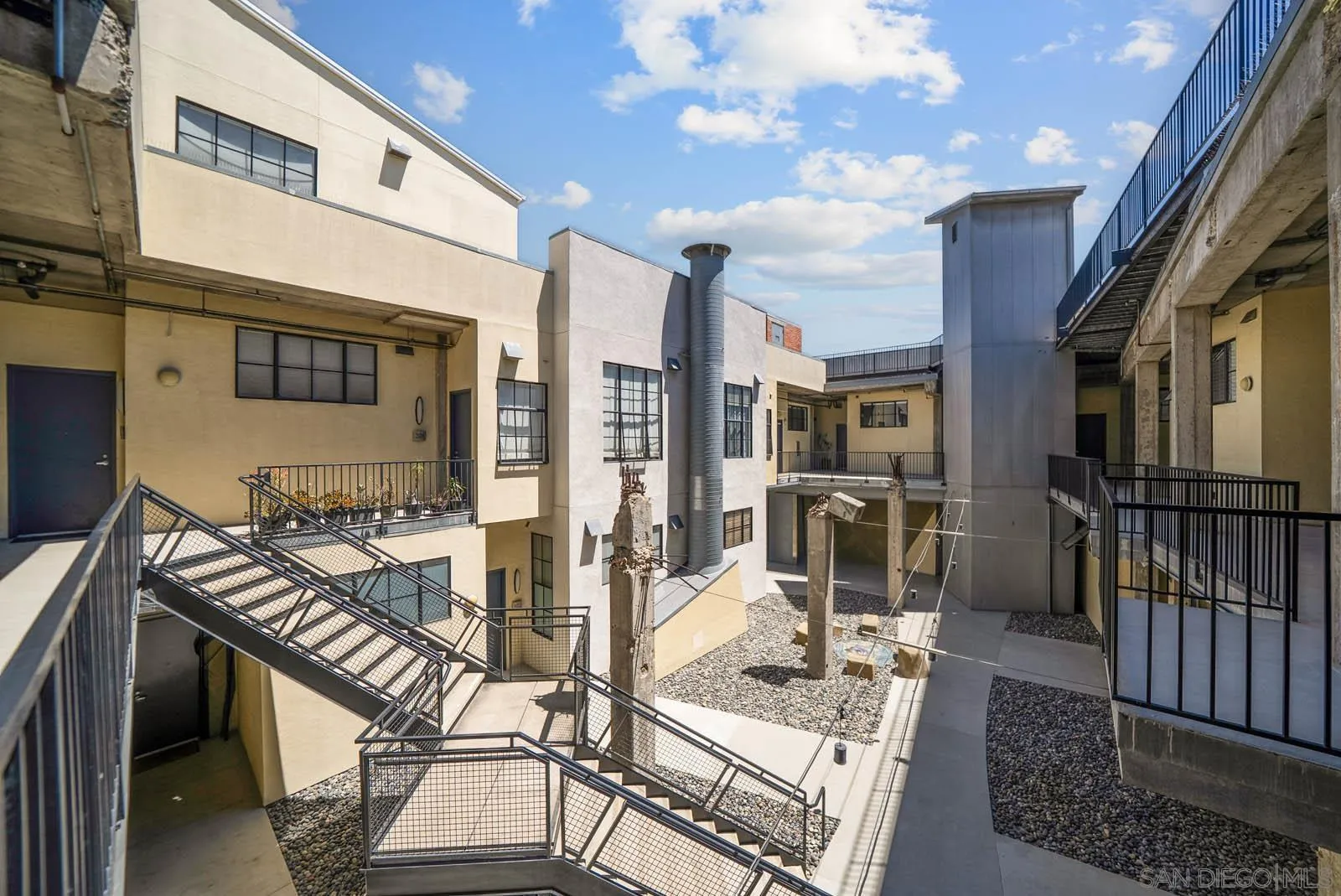 3940 7th Avenue, Unit 206 San Diego, CA 92103 - Photo 8 of 54 a view of a patio with couches table and chairs with wooden floor