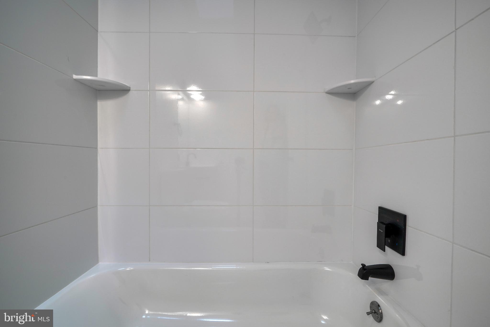 7233 Brookfalls Terrace Baltimore, MD 21209 - Photo 13 of 26 a bathroom with a shower and a bathtub