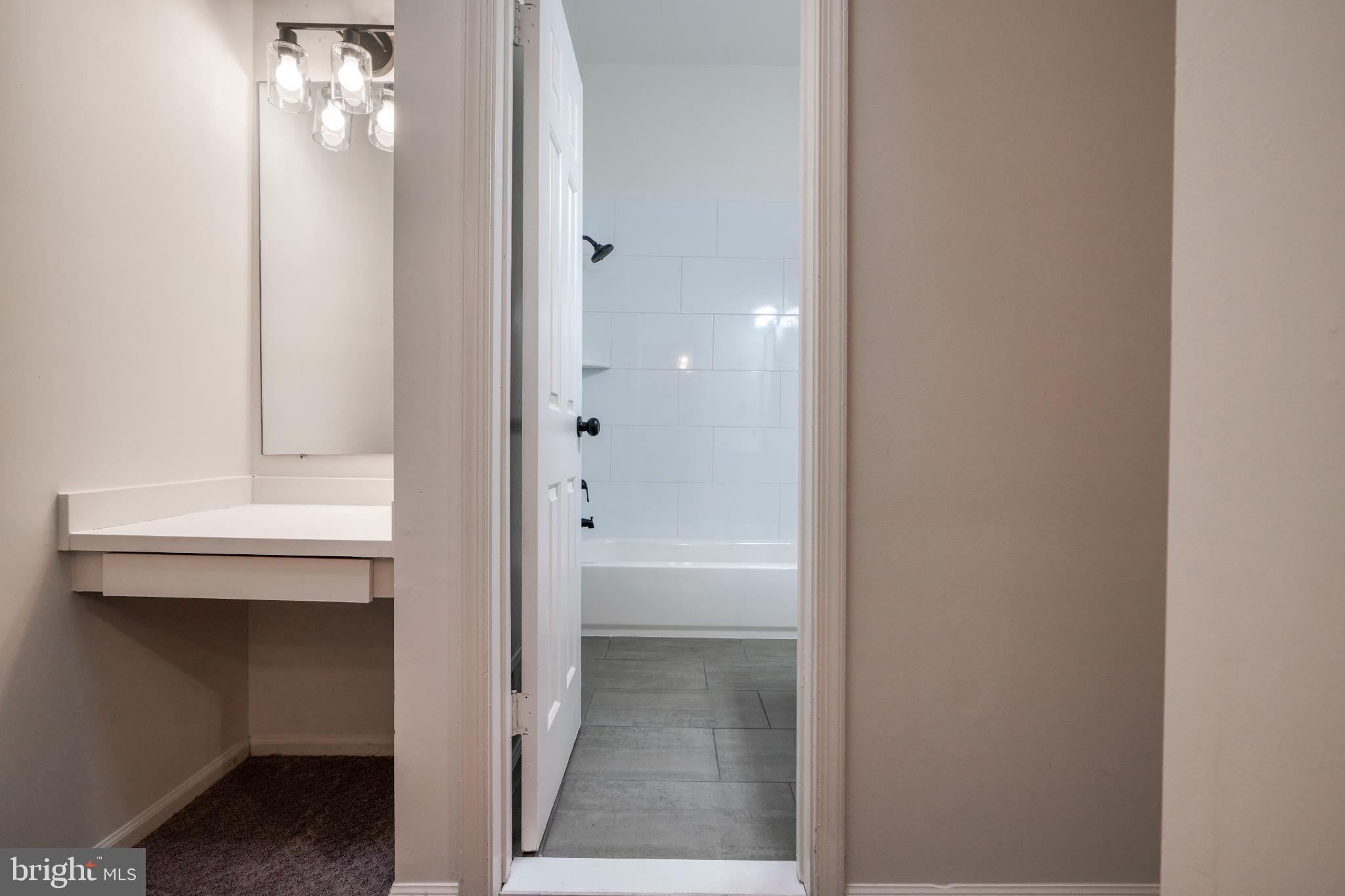 7233 Brookfalls Terrace Baltimore, MD 21209 - Photo 17 of 26 a bathroom with a sink and mirror