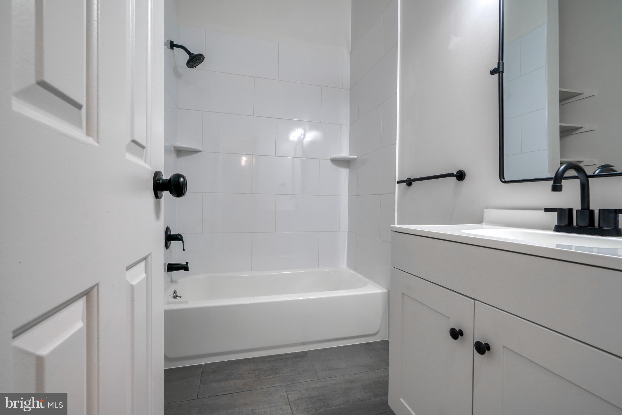 7233 Brookfalls Terrace Baltimore, MD 21209 - Photo 18 of 26 a bathroom with a bathtub and a sink
