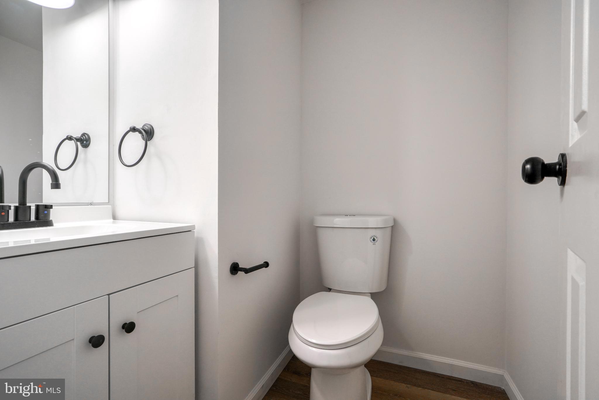 7233 Brookfalls Terrace Baltimore, MD 21209 - Photo 23 of 26 a bathroom with a toilet sink and mirror
