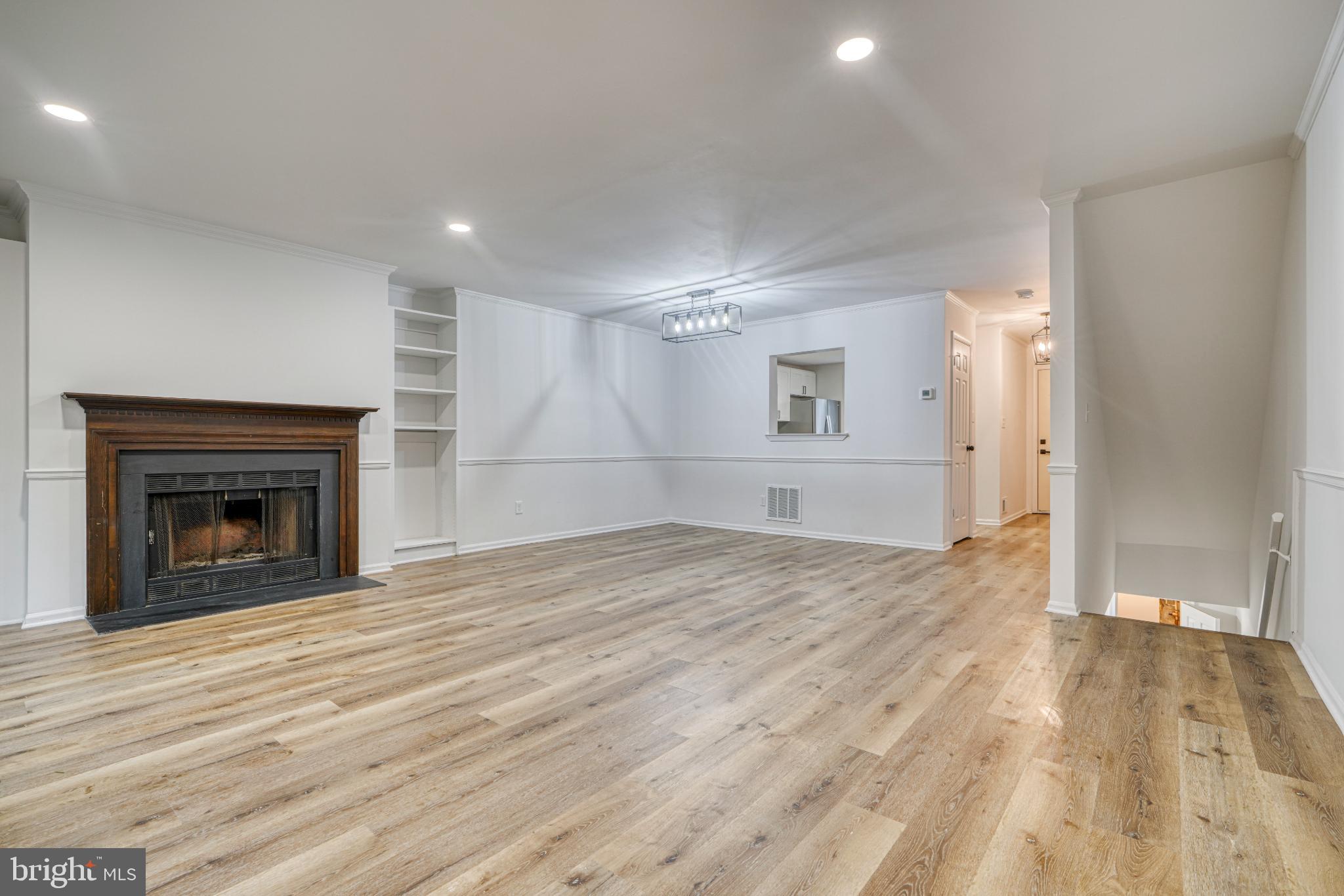 7233 Brookfalls Terrace Baltimore, MD 21209 - Photo 3 of 26 a view of empty room with wooden floor and fireplace