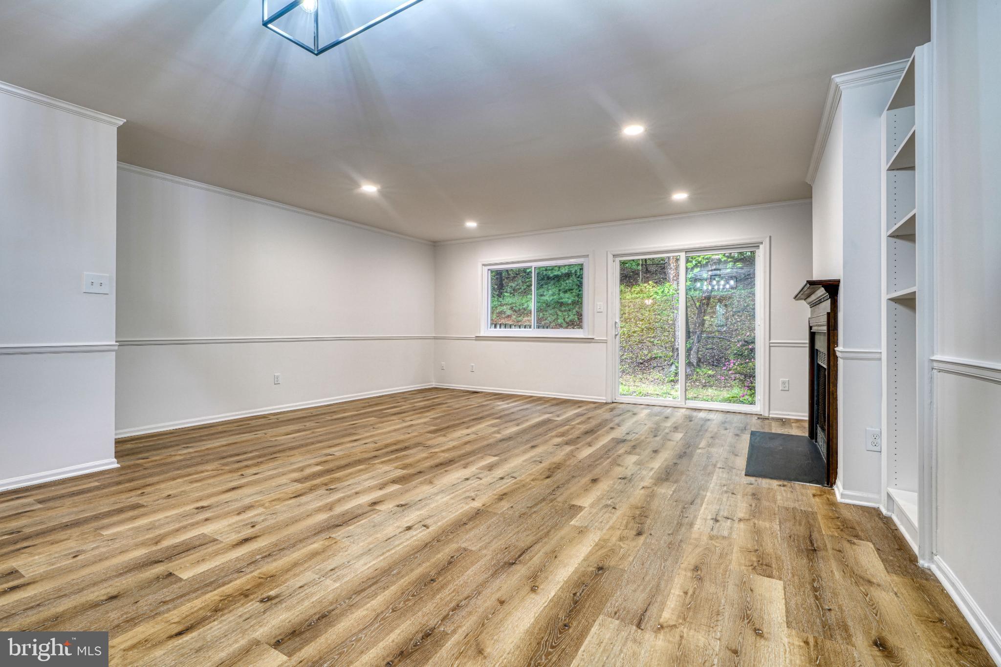 7233 Brookfalls Terrace Baltimore, MD 21209 - Photo 6 of 26 a view of empty room with wooden floor and fan