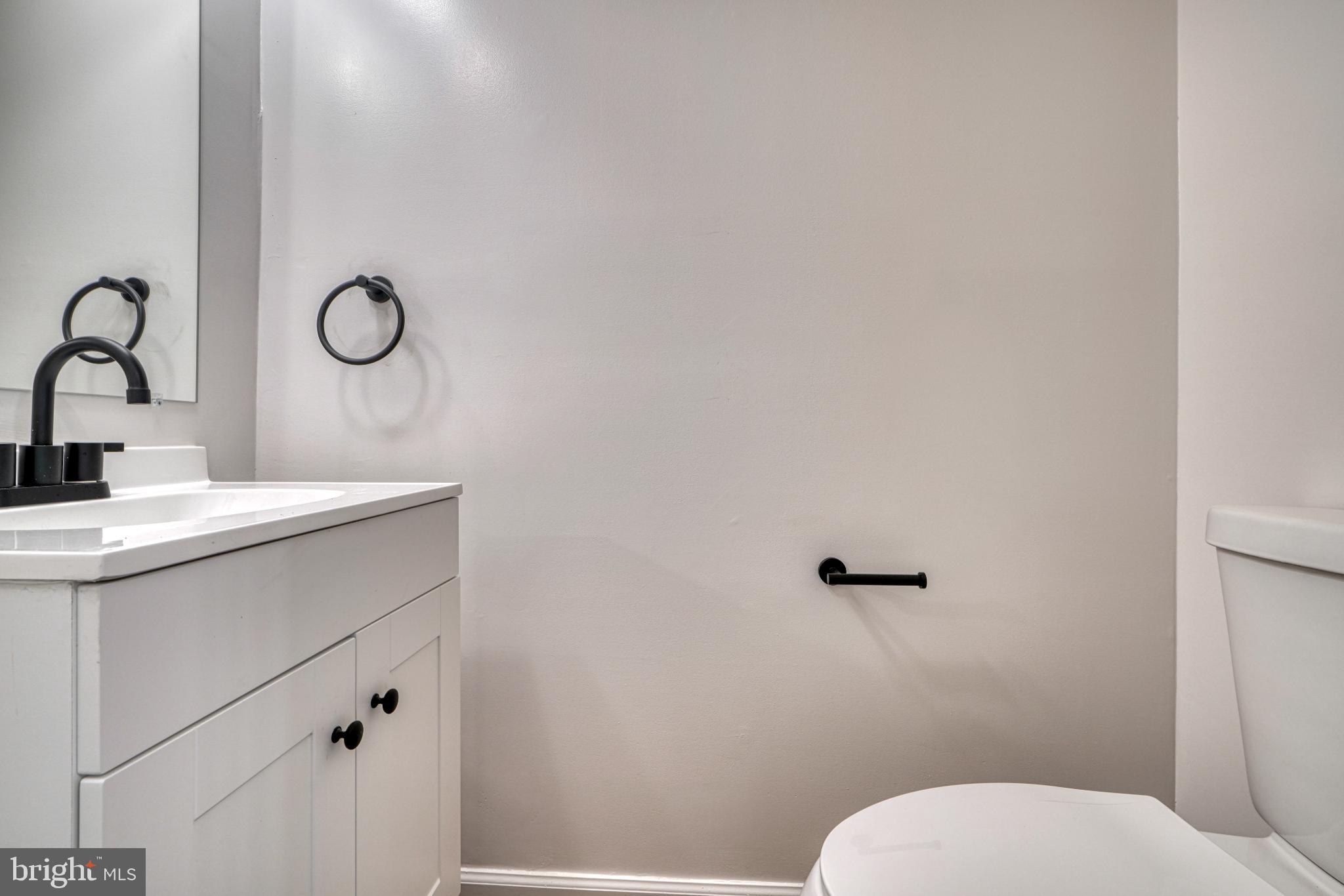 7233 Brookfalls Terrace Baltimore, MD 21209 - Photo 8 of 26 a bathroom with a toilet a sink and mirror