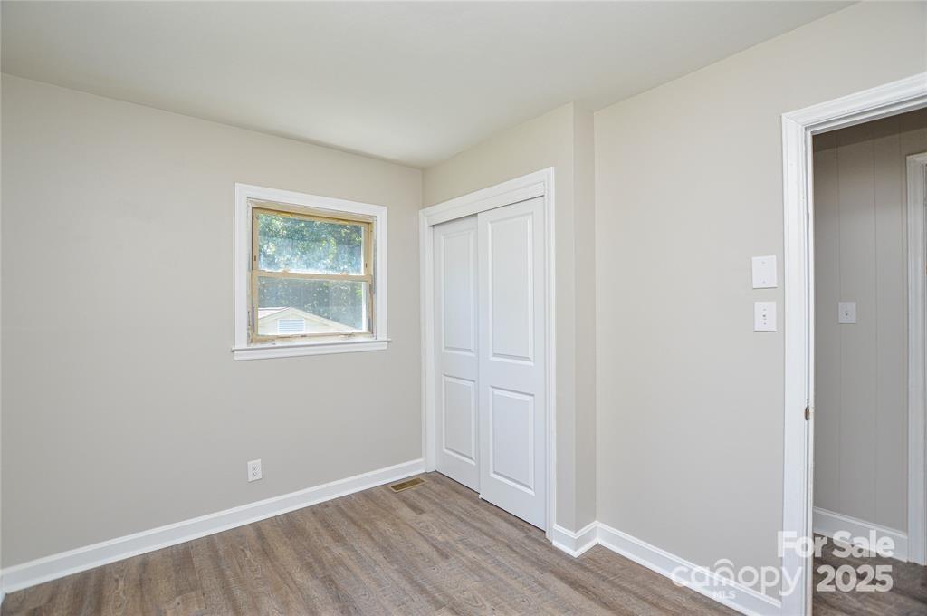 116 Brymer Road Gastonia, NC 28056 - Photo 12 of 21 a view of an empty room with wooden floor and a window