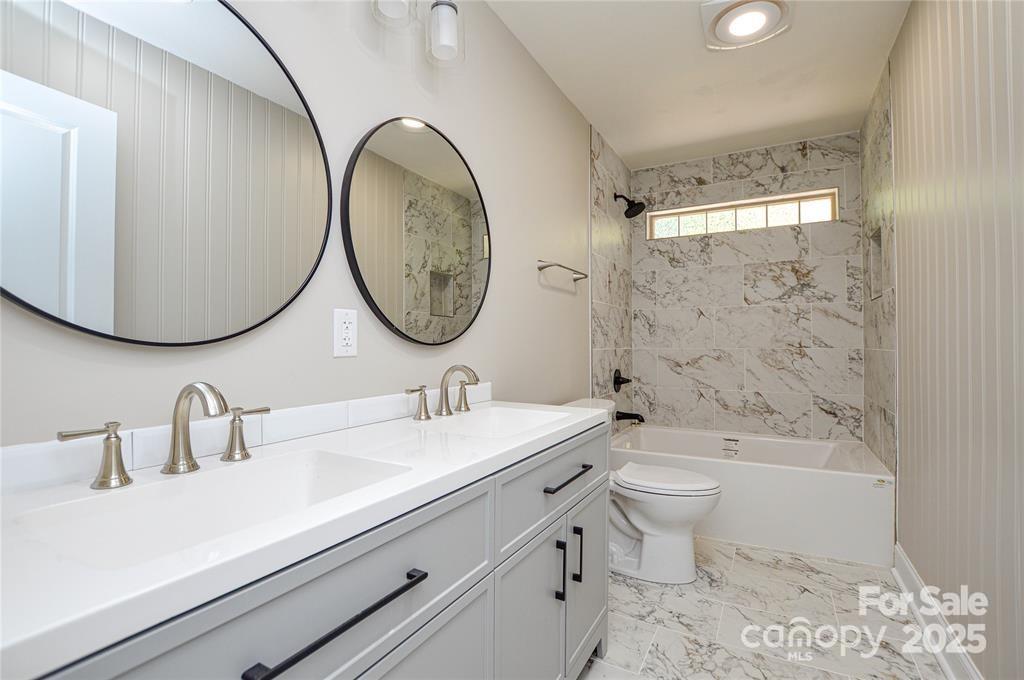 116 Brymer Road Gastonia, NC 28056 - Photo 13 of 21 a bathroom with a toilet a sink and a mirror