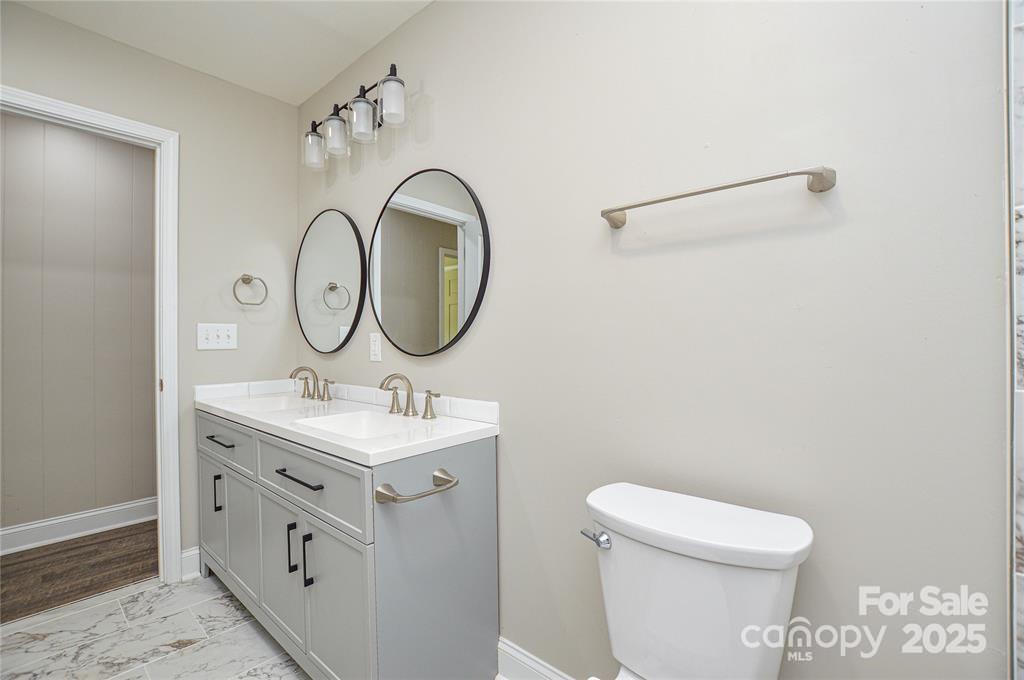 116 Brymer Road Gastonia, NC 28056 - Photo 15 of 21 a bathroom with a toilet a sink and a mirror
