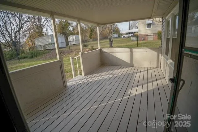 a view of a balcony with wooden floor